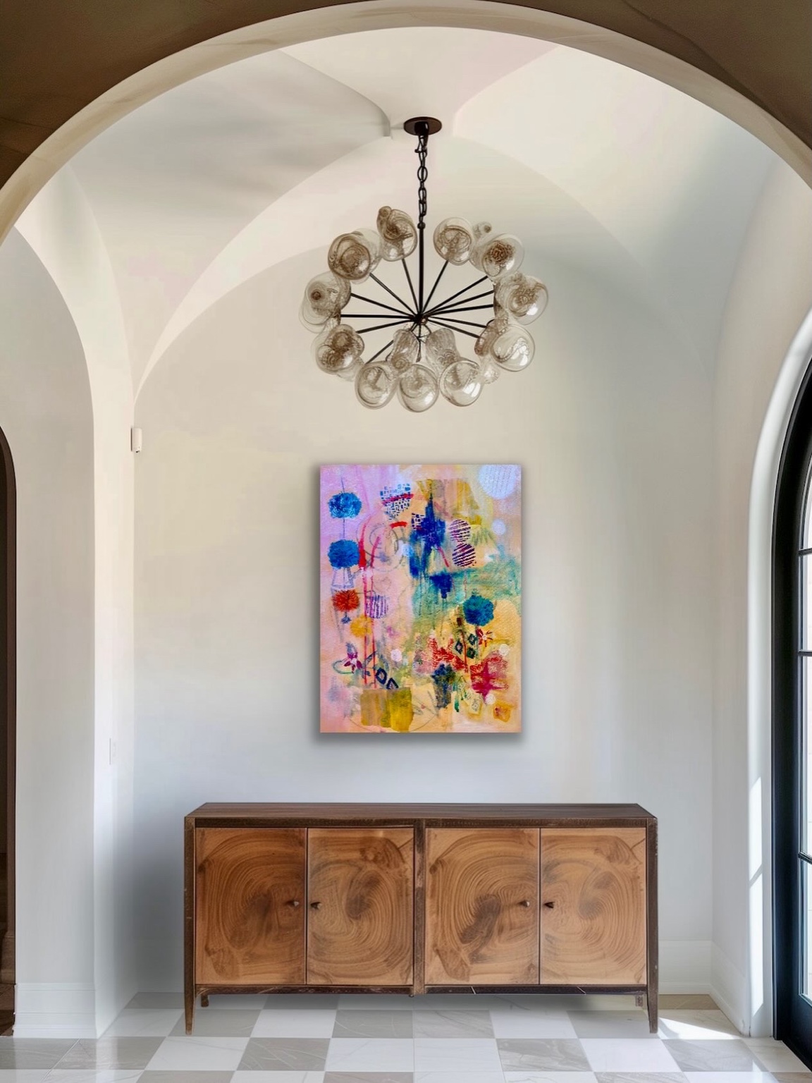 Colorful painting displayed above a wooden cabinet in an arched interior